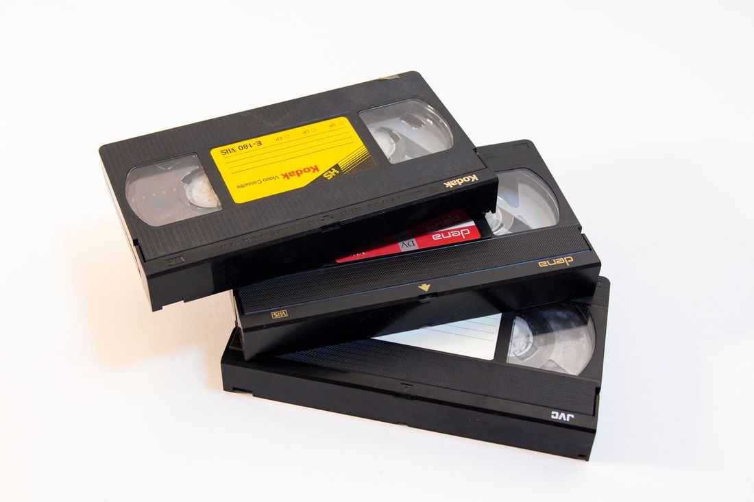 Three VHS tapes stacked on a white background